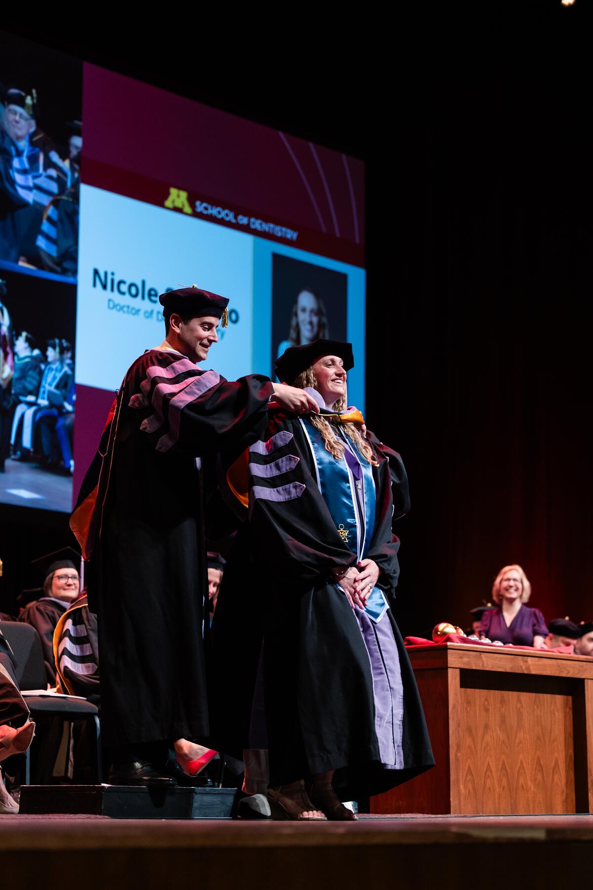 Graduate being hooded at commencement