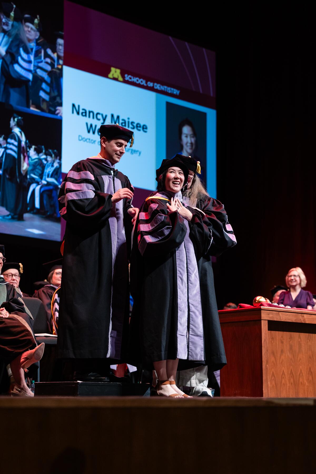 Graduate being hooded at commencement