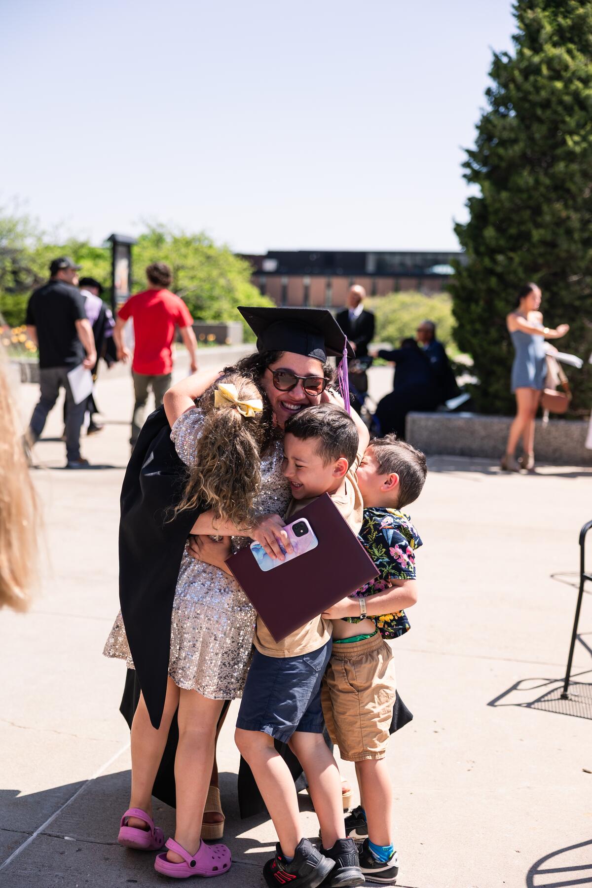 Graduate at commencement with children