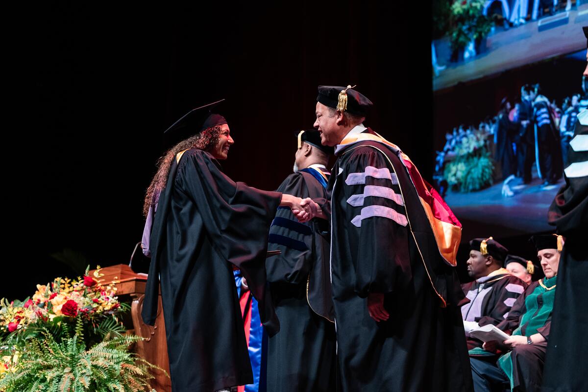 Graduate shaking hands at commencement