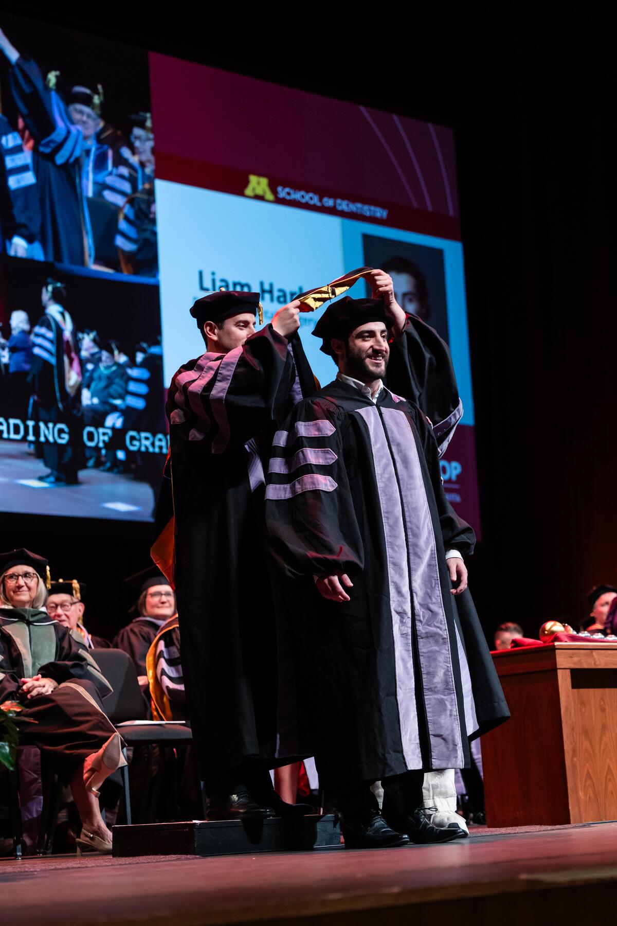 Graduate being hooded at commencement