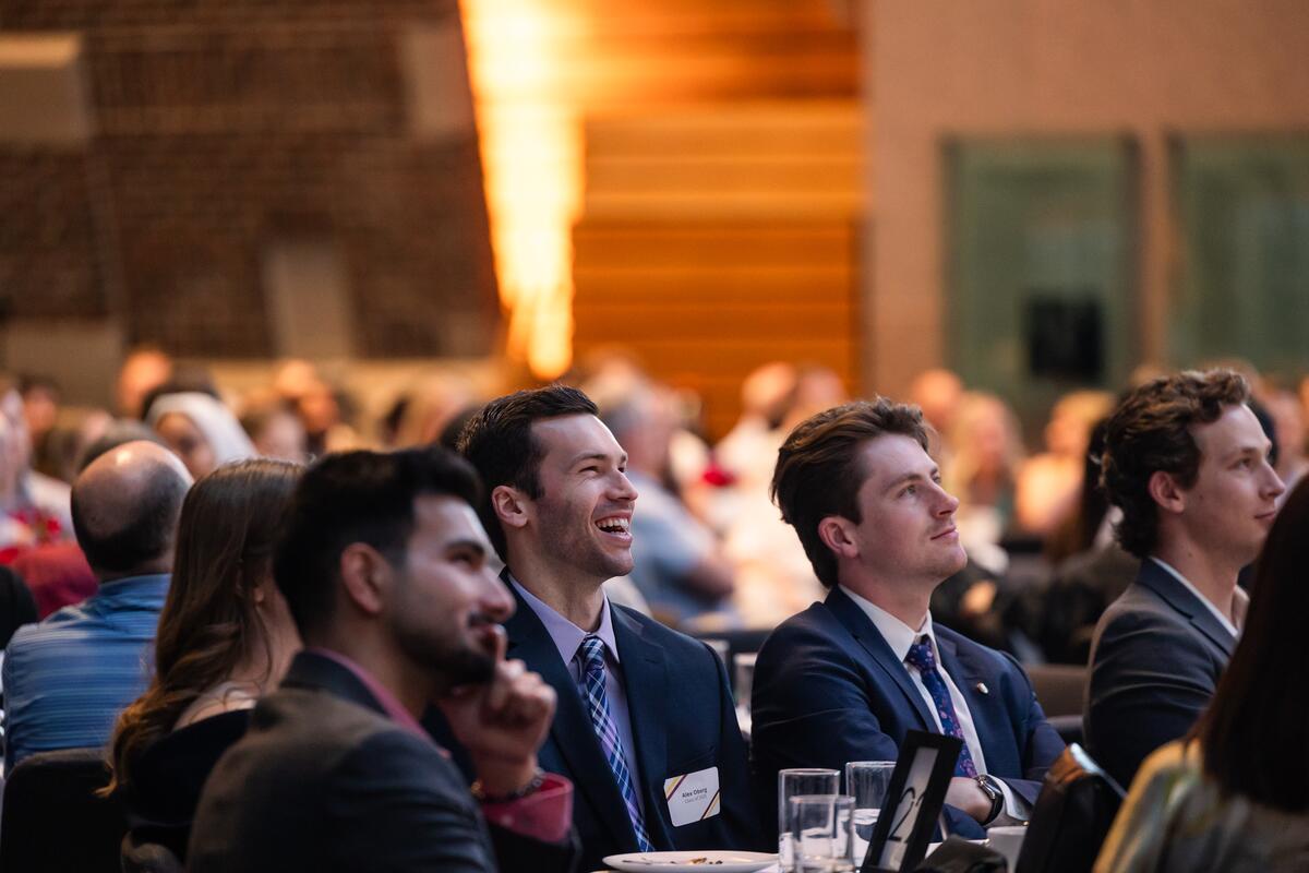 Attendees smile as they watch a presentation at the DDS Awards Ceremony