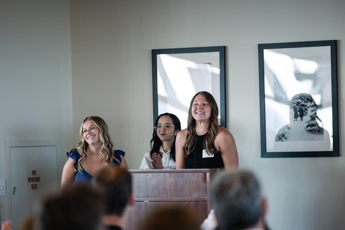 Class officers share remarks from behind a podium