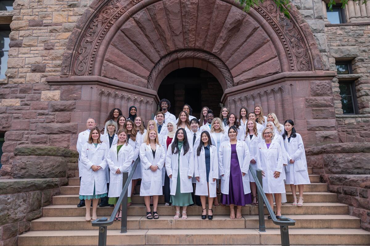 Group shot of the Dental Hygiene Class of 2027 in their white coats
