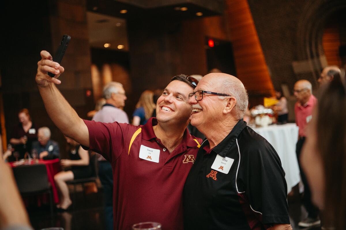 two alumni weekend attendees take a selfie together
