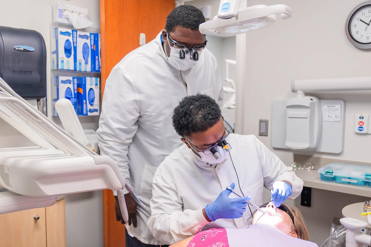 Michael Brooks oversees a student providing care to a patient