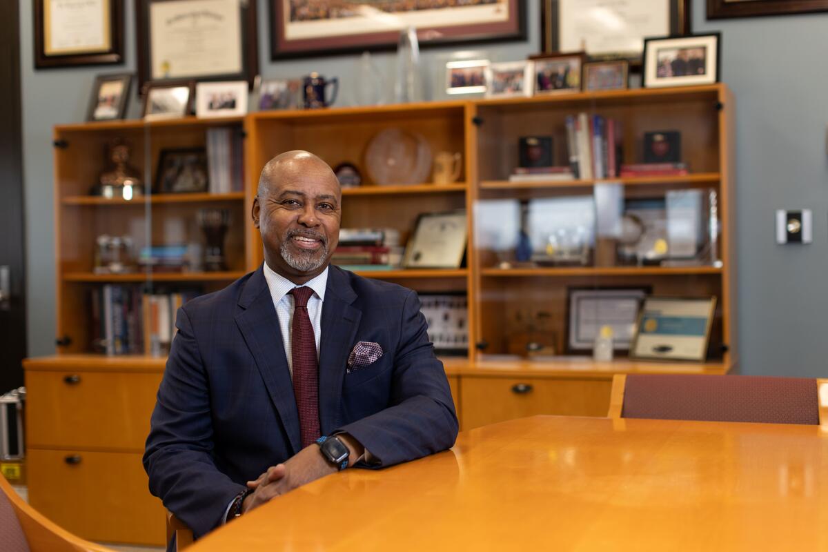 Dean Keith Mays sits at a table in his office in Moos Tower