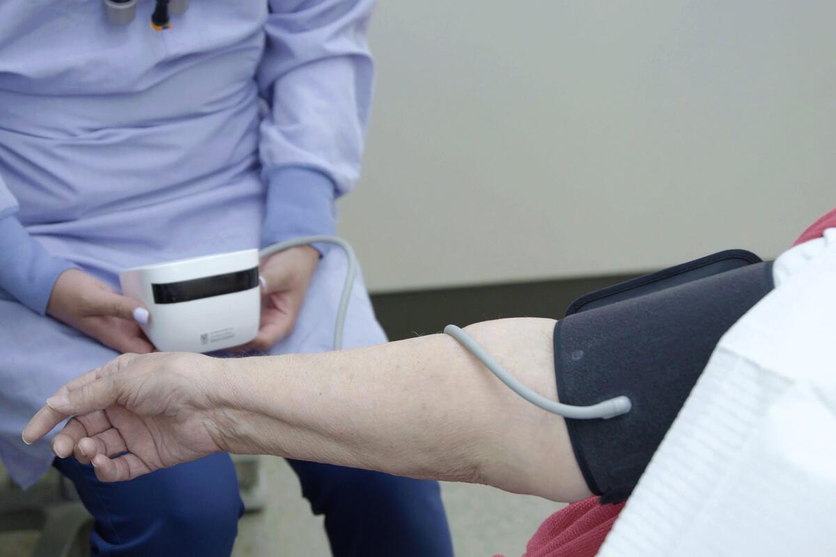 DDS student takes a patient's blood pressure
