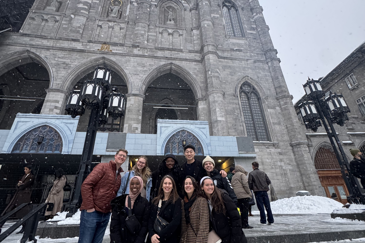 Students and faculty pose in front of a cathedral in Montreal