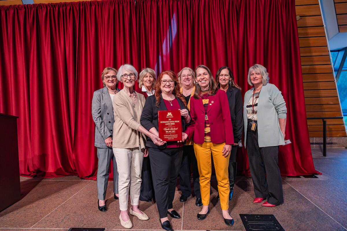 dental hygiene alumni stand with distinguished alumni award winner
