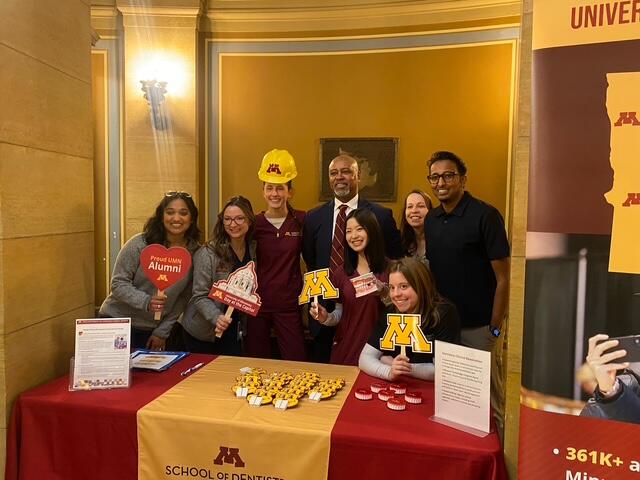dean keith mays poses with dental students at the state capitol building