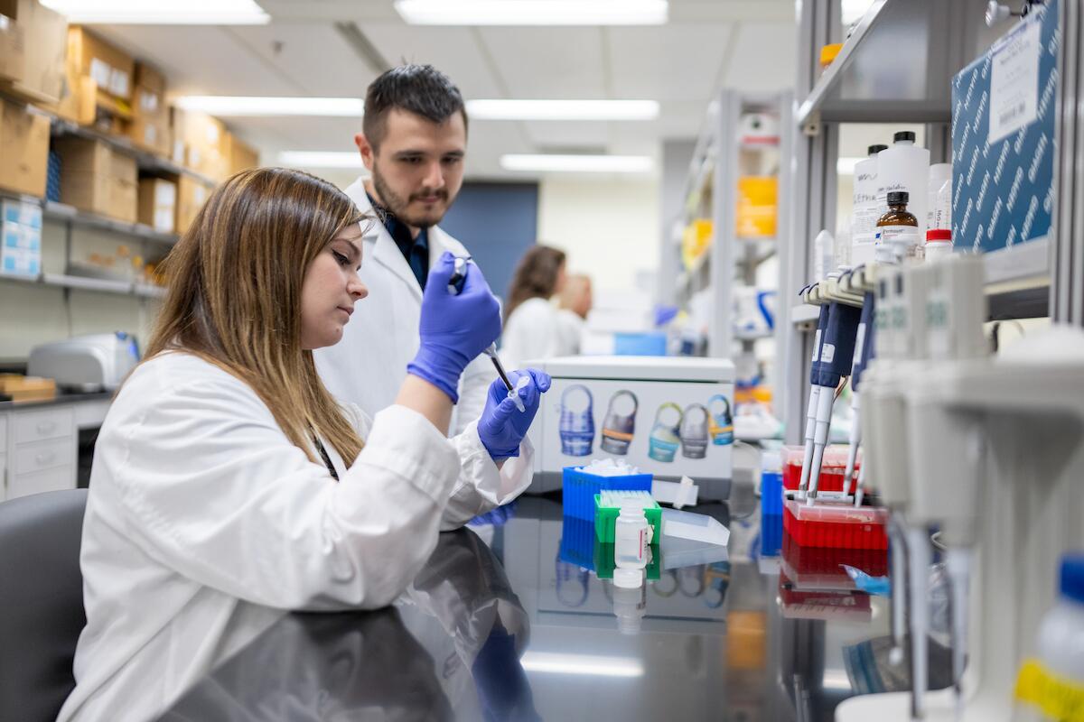 two oral biology students work in a lab