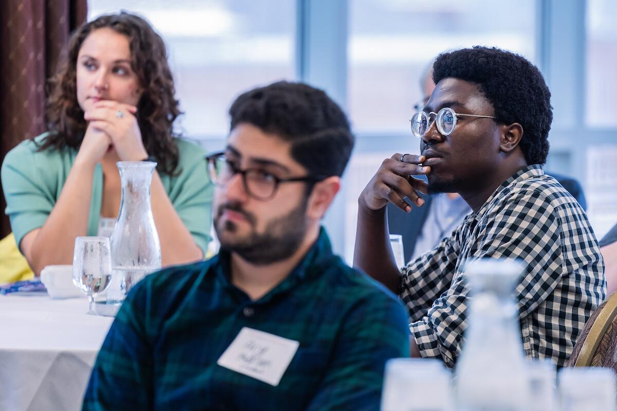 Three oral biology students attend a symposium