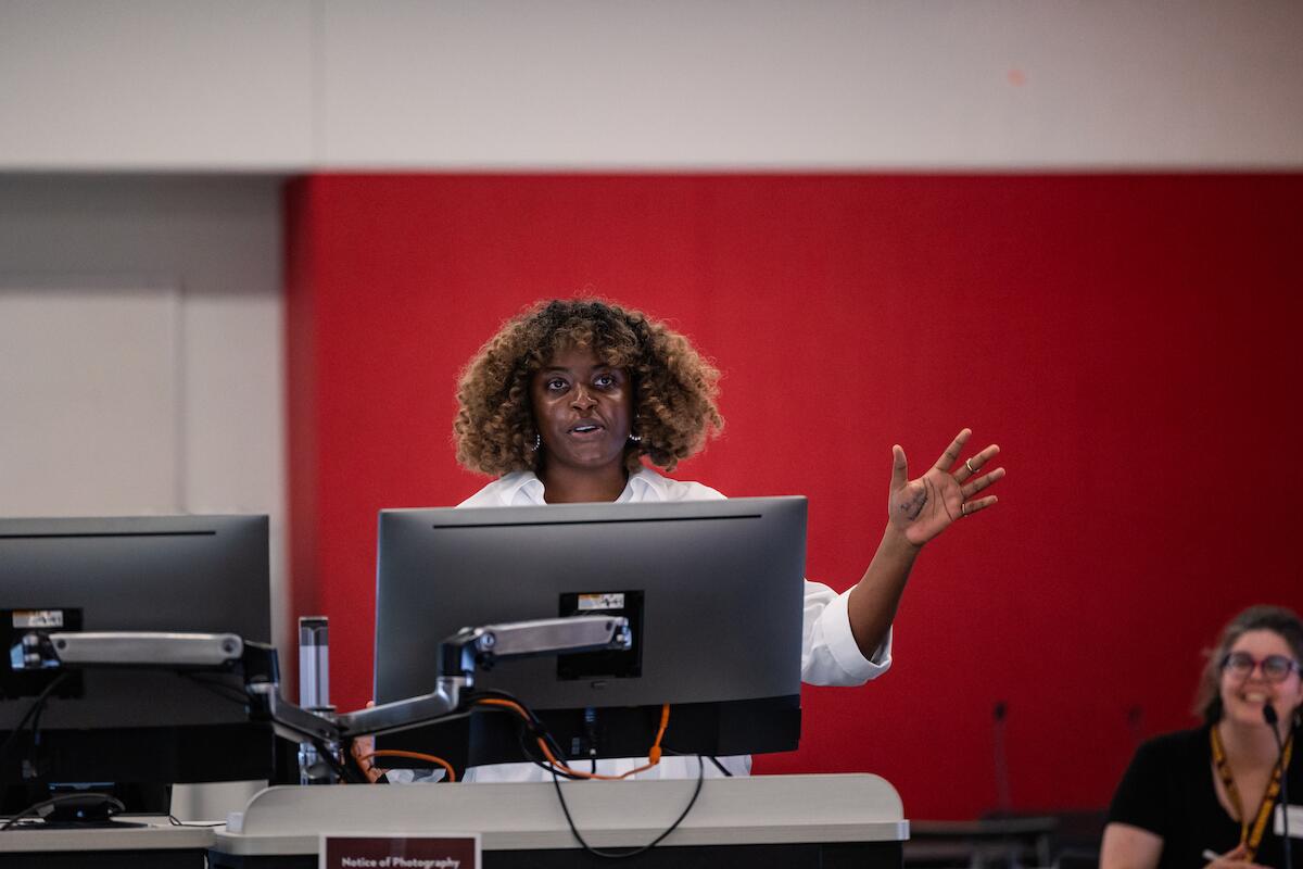 an oral biology student presents behind a computer