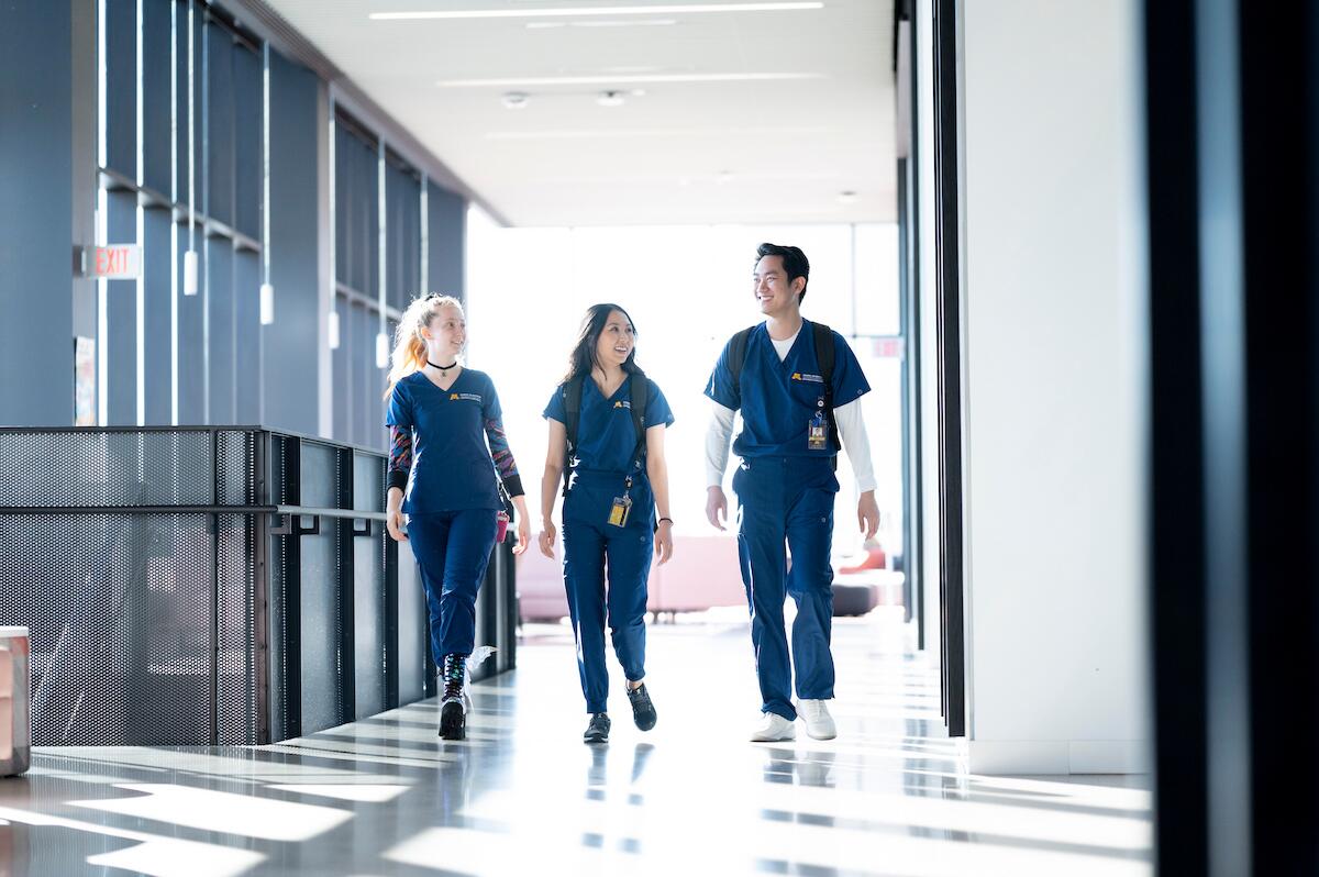 School of Dentistry students walk down a hallway