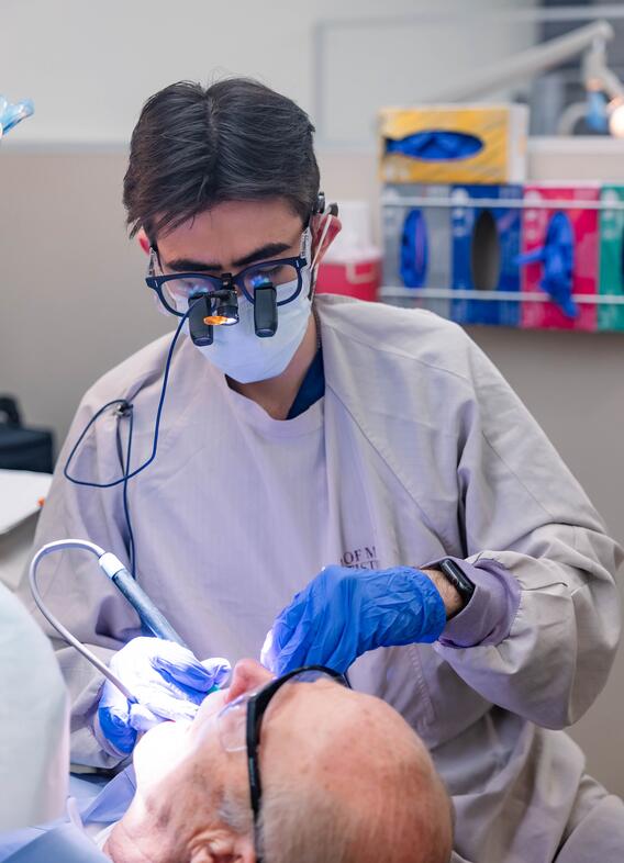 Alex Tabatabai in clinic with a patient