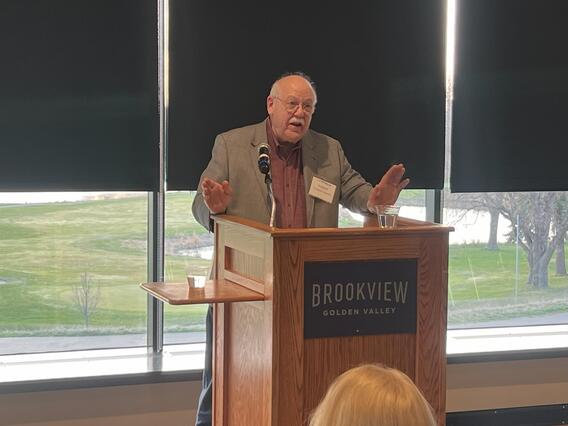 Shuman speaking at award
