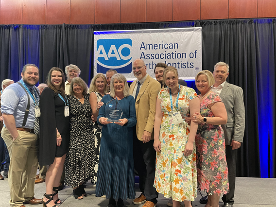 Cheryl Anderson Cermin and others pose with her award 