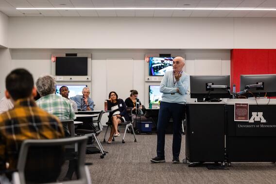 Jorge Perdigao speaks to a participant near the podium