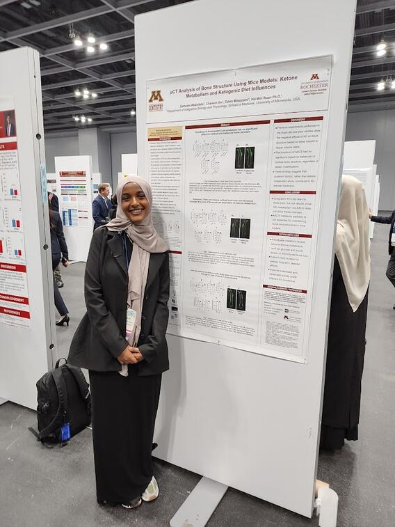 Zamzam Abudllahi poses with her research poster
