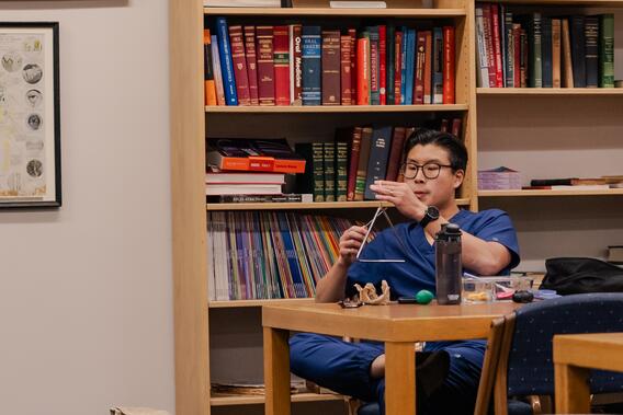 Student plays the triangle