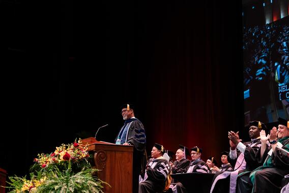 Dean Mays smiles as he addresses graduates