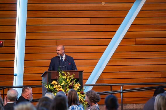 Dean Keith Mays smiles behind the podium at McNamara Alumni Center