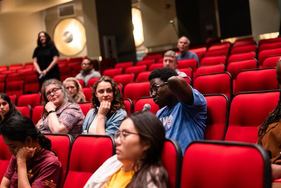 An attendee asks a question from the audience at Research Innovations