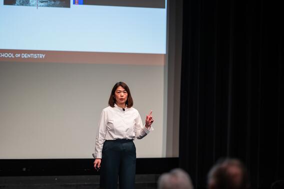 Hooi Pin Chew presents onstage at Research Innovations