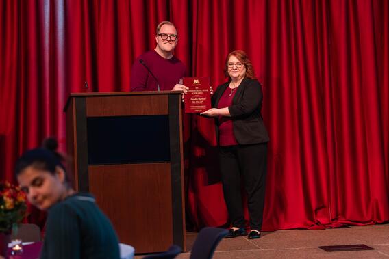 Kandis Garland poses with her Distinguished Alumni Award with Robert Springer