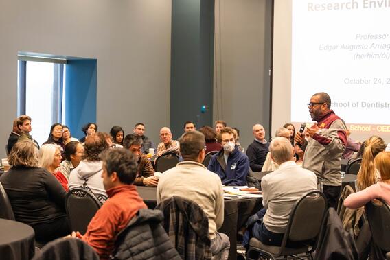 Attendees talk in small groups for breakout discussions
