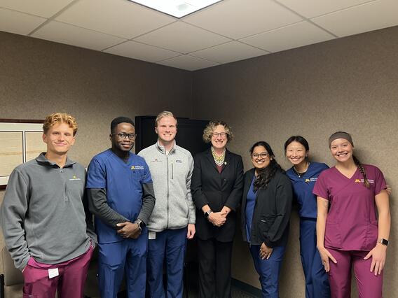 Cunningham poses with a group of students at CentraCare
