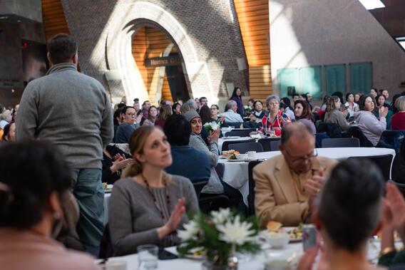 Attendees applaud service awardees at the winter celebration