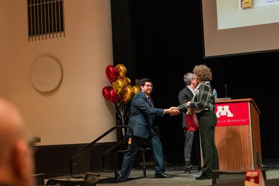 First-prize poster winner Johan Alfaro Carballo receives his award