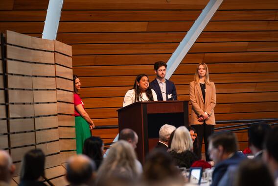 Patnayak speaks from the podium while her fellow class officers look on