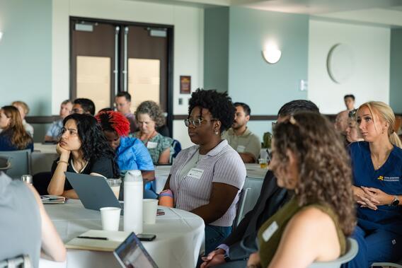 Students and researchers listen to presentations during the AADOCR Research Exchange