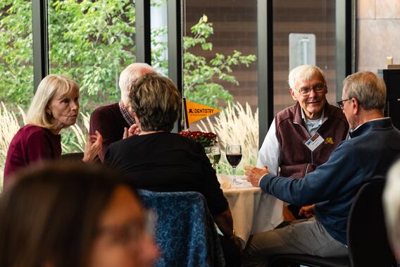 Attendees chat during the Alumni Weekend reception