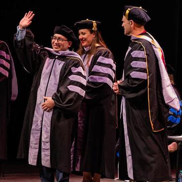 three faculty at commencement 2023