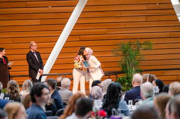 Woman accepting award at DDS ceremony.
