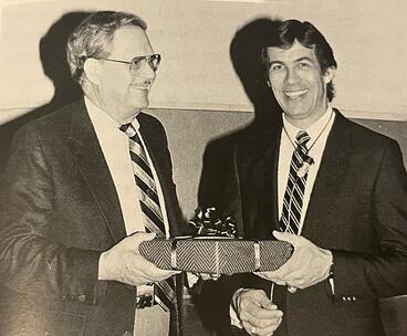 Elzay giving gift to Kenneth Zakariasen