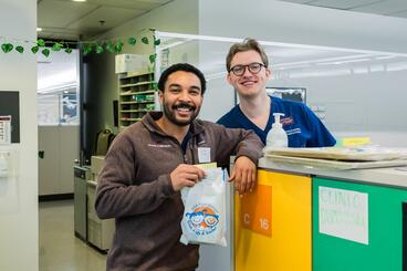 Dental students hold "goodie bags" given to each patient