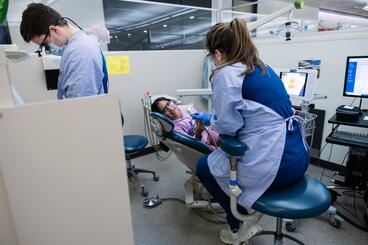 Child smiles while receiving dental care