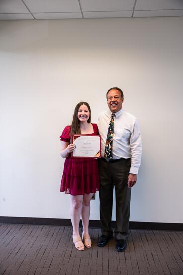 Kaitlyn Niemann poses with her award alongside Karl Self