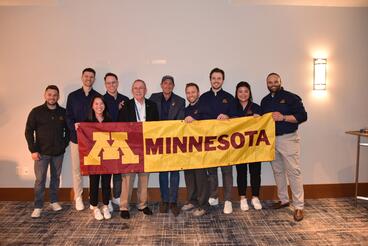 Minnesota delegation to American Association of Endodontists Annual Meeting with University of Minnesota banner