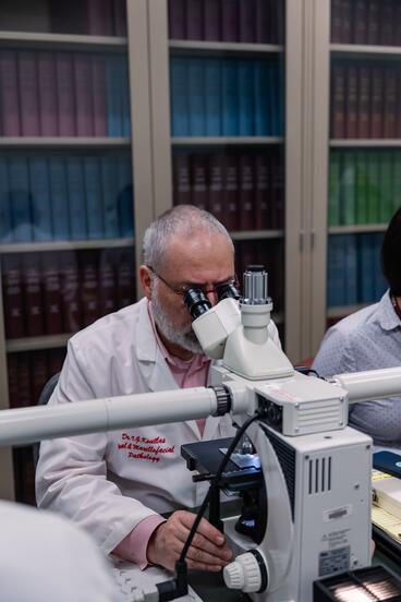 Man looking through microscope