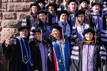 Group photo of graduates taking selfie