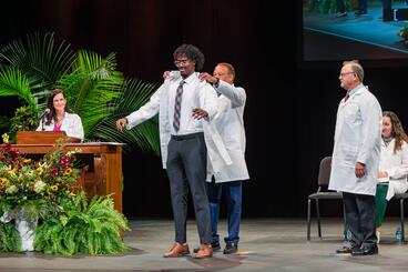 Student receives their White Coat onstage