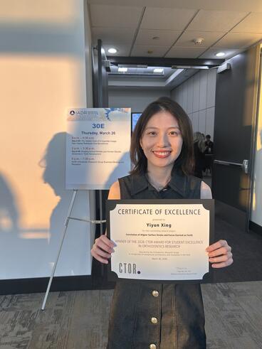 Yiyun Xing poses with her Certificate of Excellence