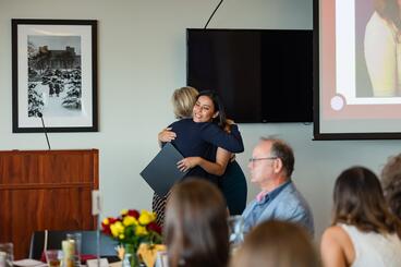 Chapman embraces Stull as she receives her award