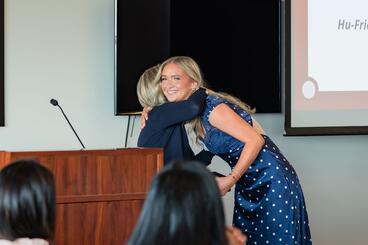 Schmidt hugs Stull as she receives her award